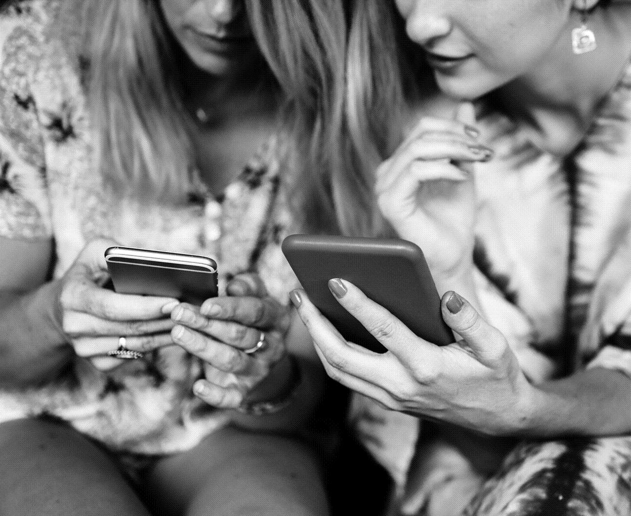 Girlfriends communicate and connected by mobile phone